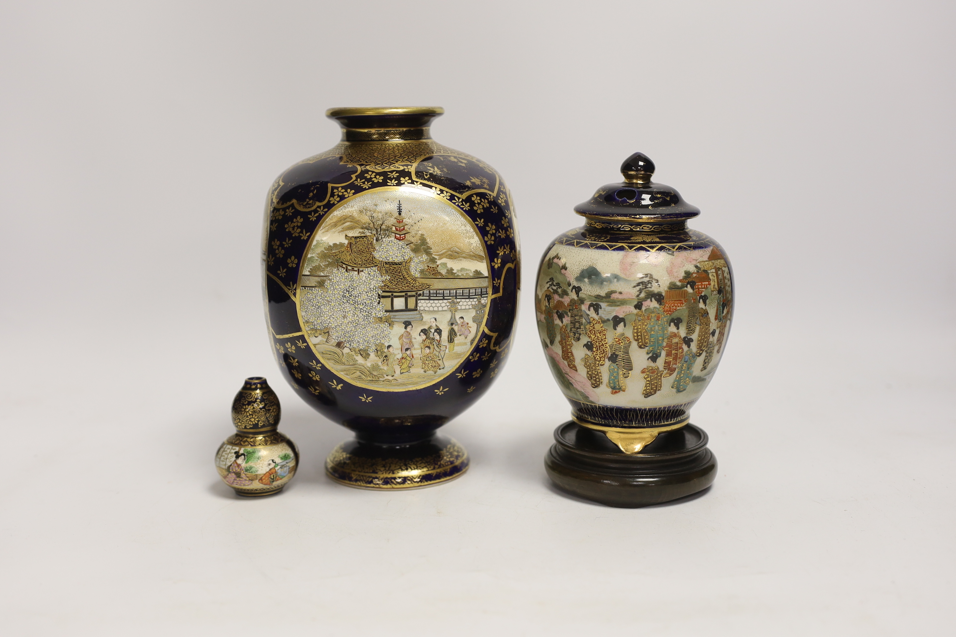 Three Japanese Satsuma vases, one with cover, one stand, tallest 19cm